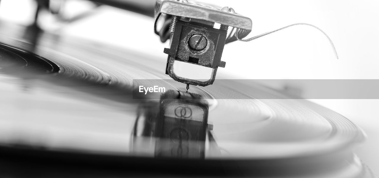 Old dusty vinyl turntable player isolated over white background.