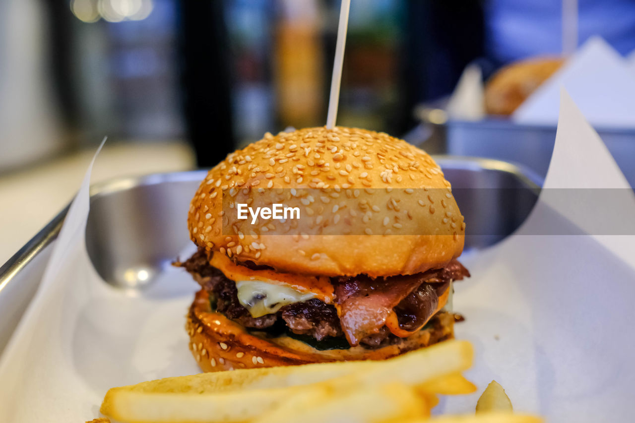fast food, hamburger, unhealthy eating, food and drink, sandwich, food, meal, dish, bun, restaurant, breakfast, business, freshness, take out food, meat, close-up, bread, lunch, french fries, plate, cheese, fried, indoors, raw potato, table, no people, veggie burger, slider, focus on foreground, selective focus, snack, beef