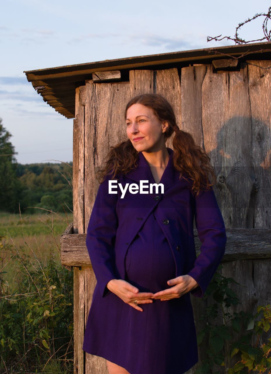 Pregnant woman standing outdoors