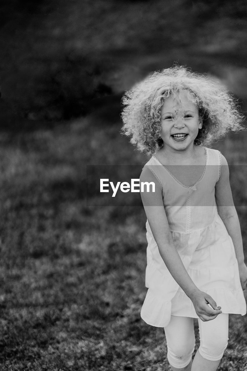 Portrait of smiling girl standing on land