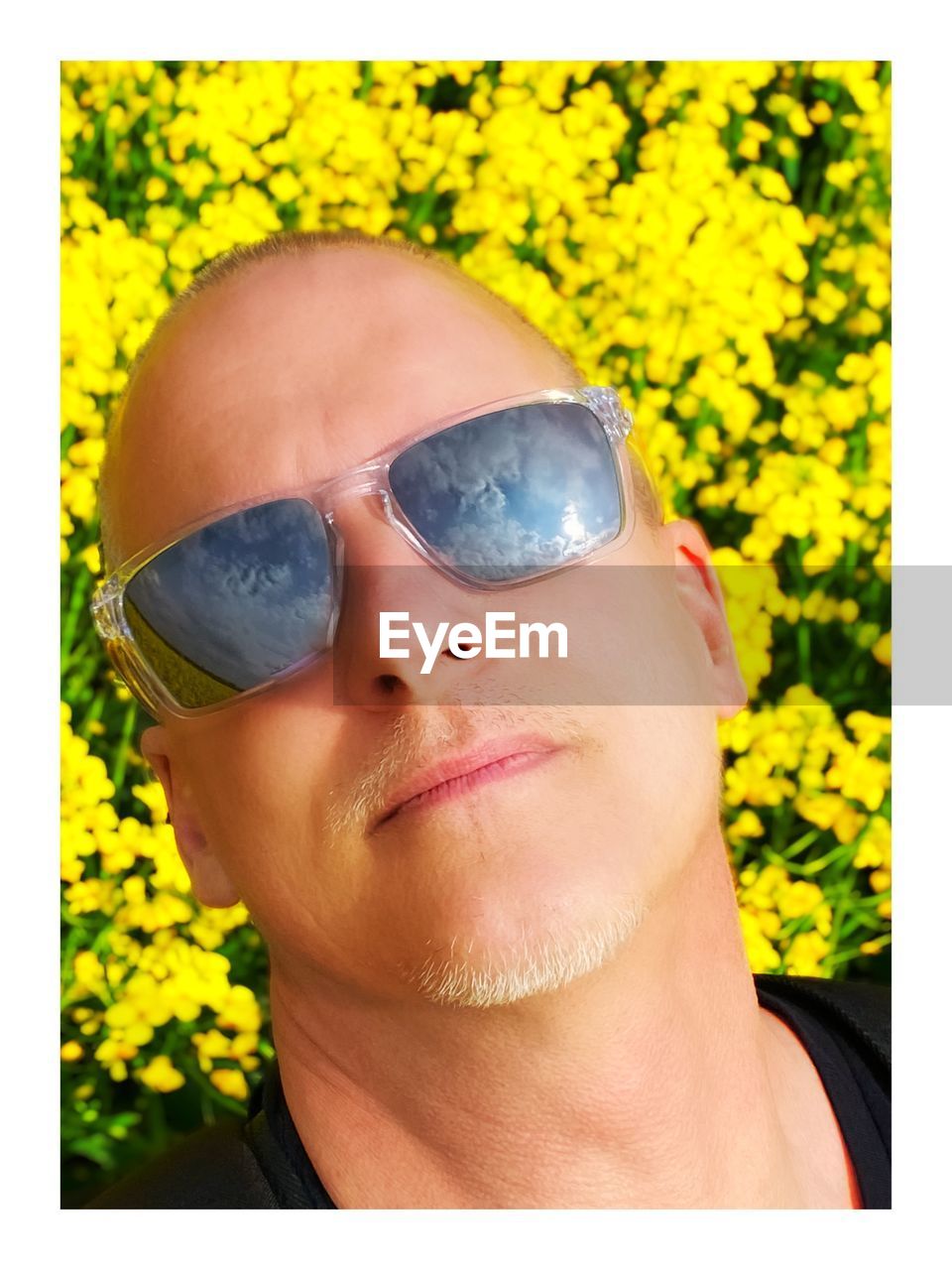 yellow, one person, headshot, portrait, glasses, sunglasses, human face, adult, fashion, nose, nature, eyewear, plant, close-up, front view, vision care, flower, transfer print, lifestyles, leisure activity, young adult, human head, flowering plant, outdoors, auto post production filter, men, smiling, summer