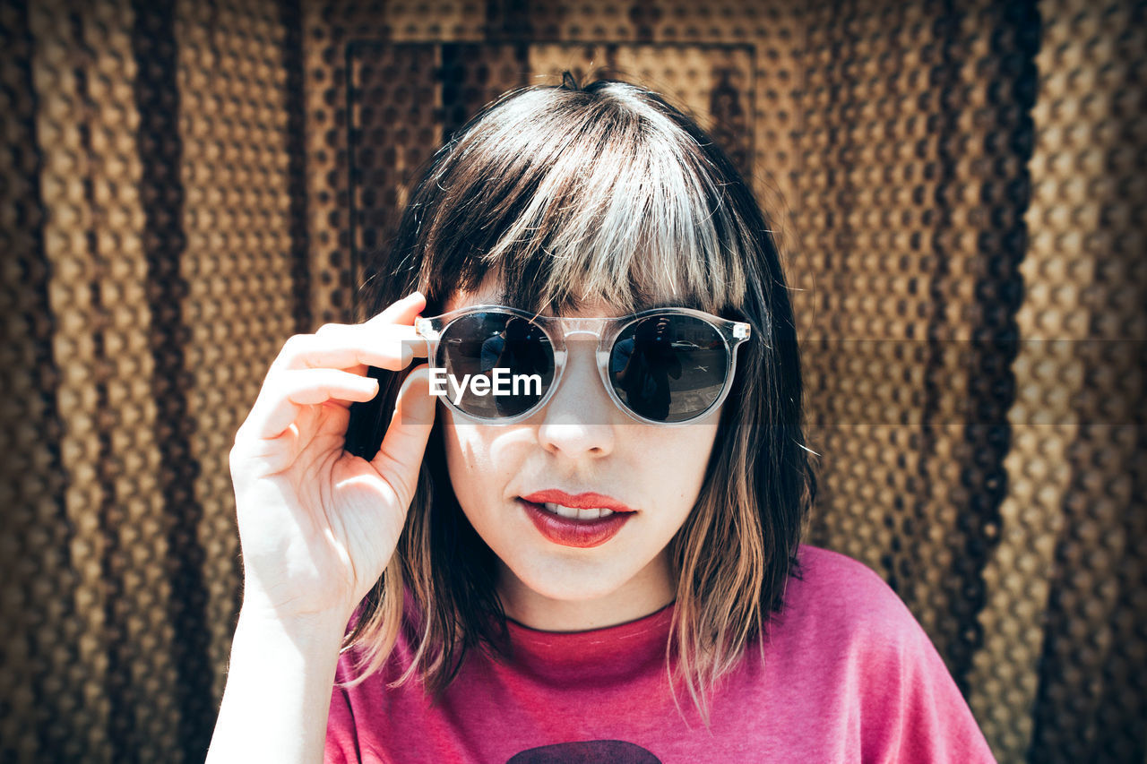 Portrait of young woman wearing sunglasses