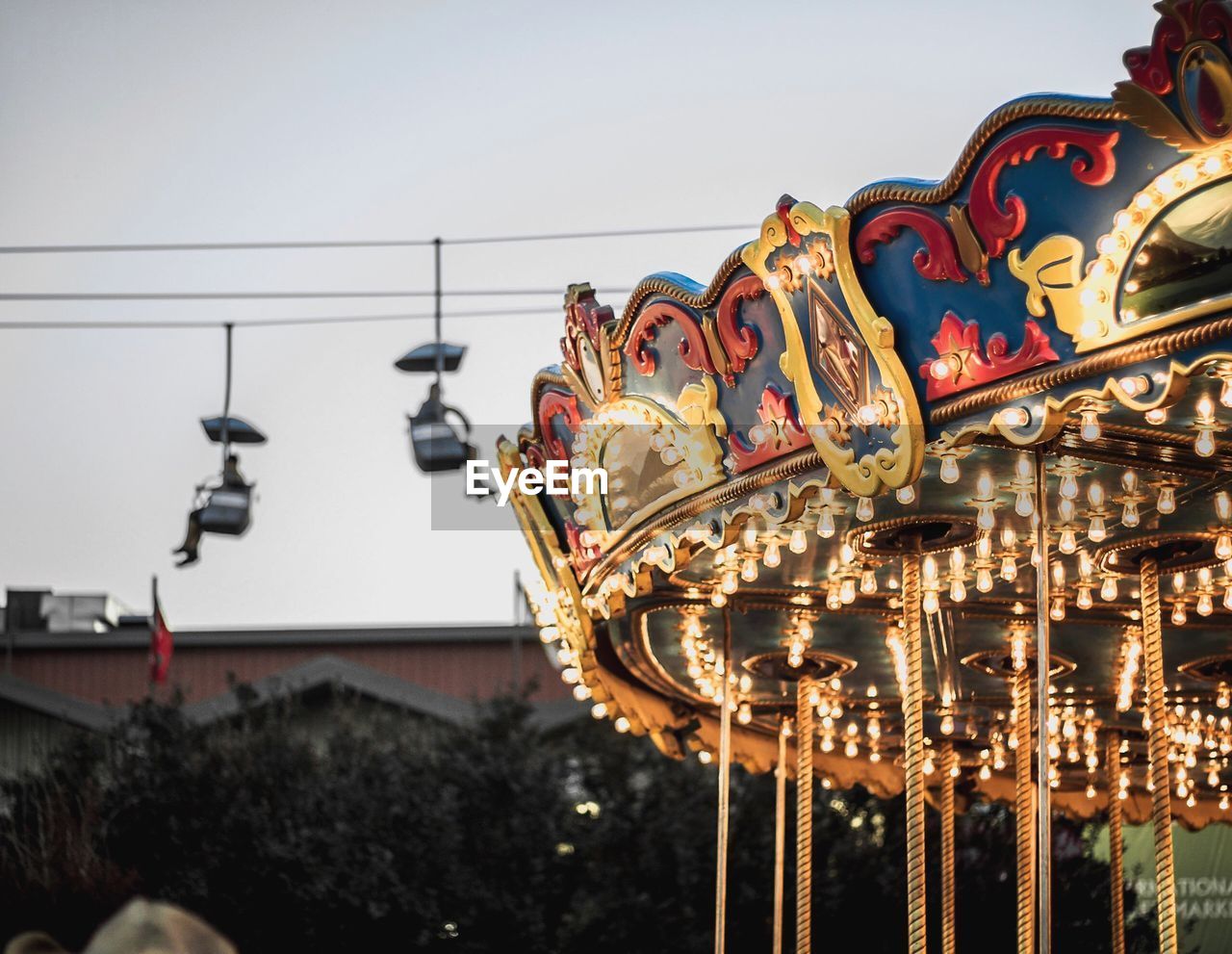 Illuminated carousel against sky