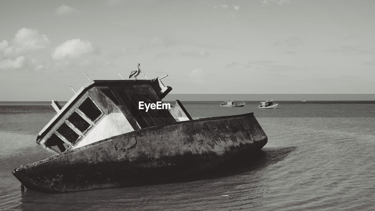 ABANDONED BOAT ON BEACH