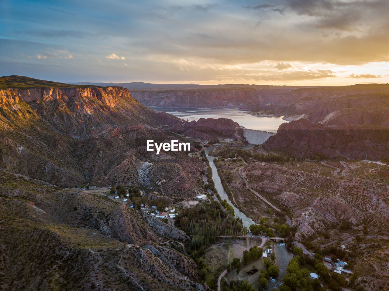 Scenic view of river against cloudy sky