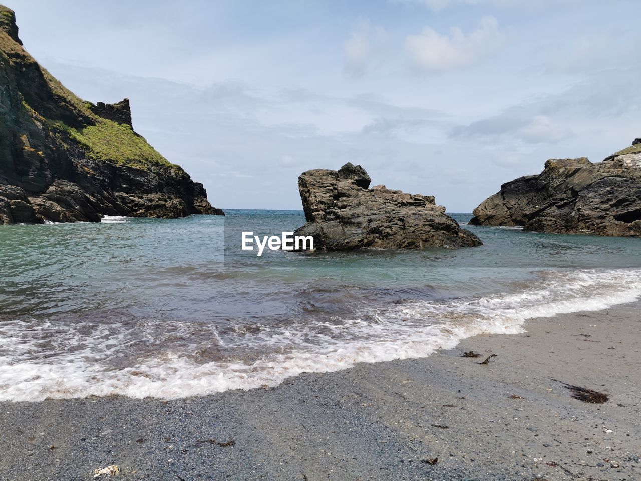 Rocks on beach against sky