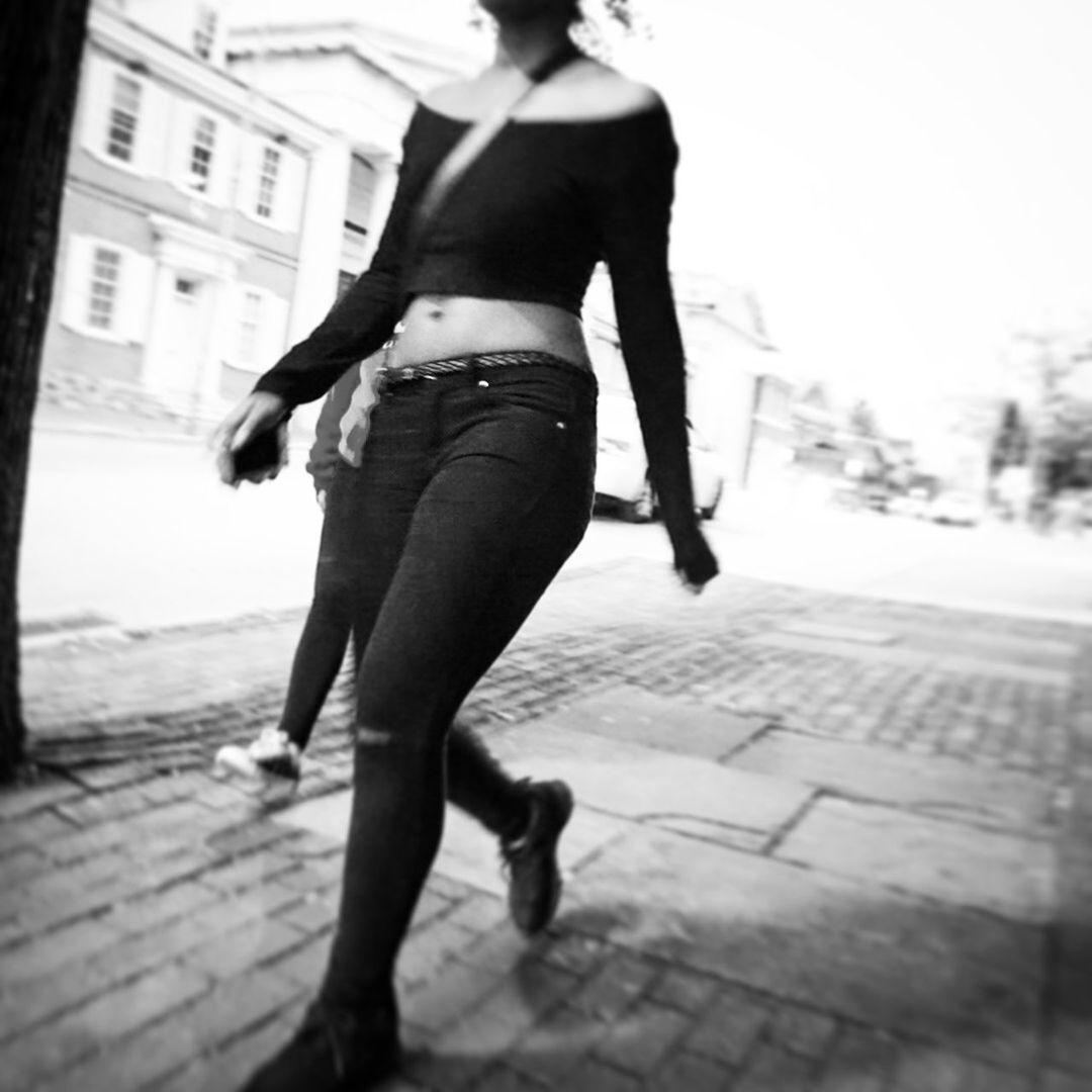 CLOSE-UP OF WOMAN STANDING ON RAILING