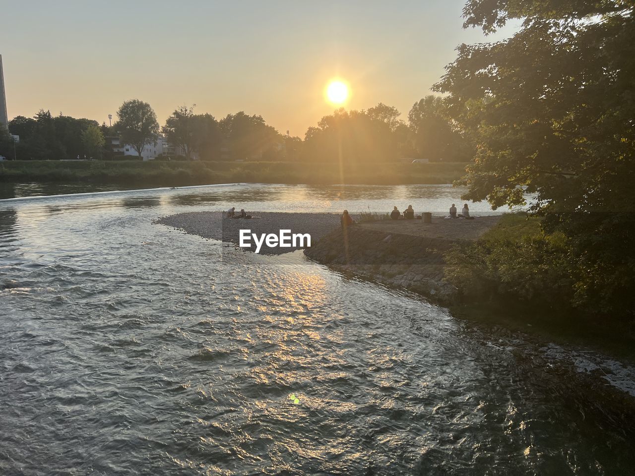 water, sky, river, morning, nature, tree, reflection, sun, beauty in nature, sunlight, plant, scenics - nature, tranquility, environment, sunrise, dawn, landscape, body of water, land, tranquil scene, shore, outdoors, architecture, travel destinations, travel, no people, idyllic, sunbeam, summer, beach