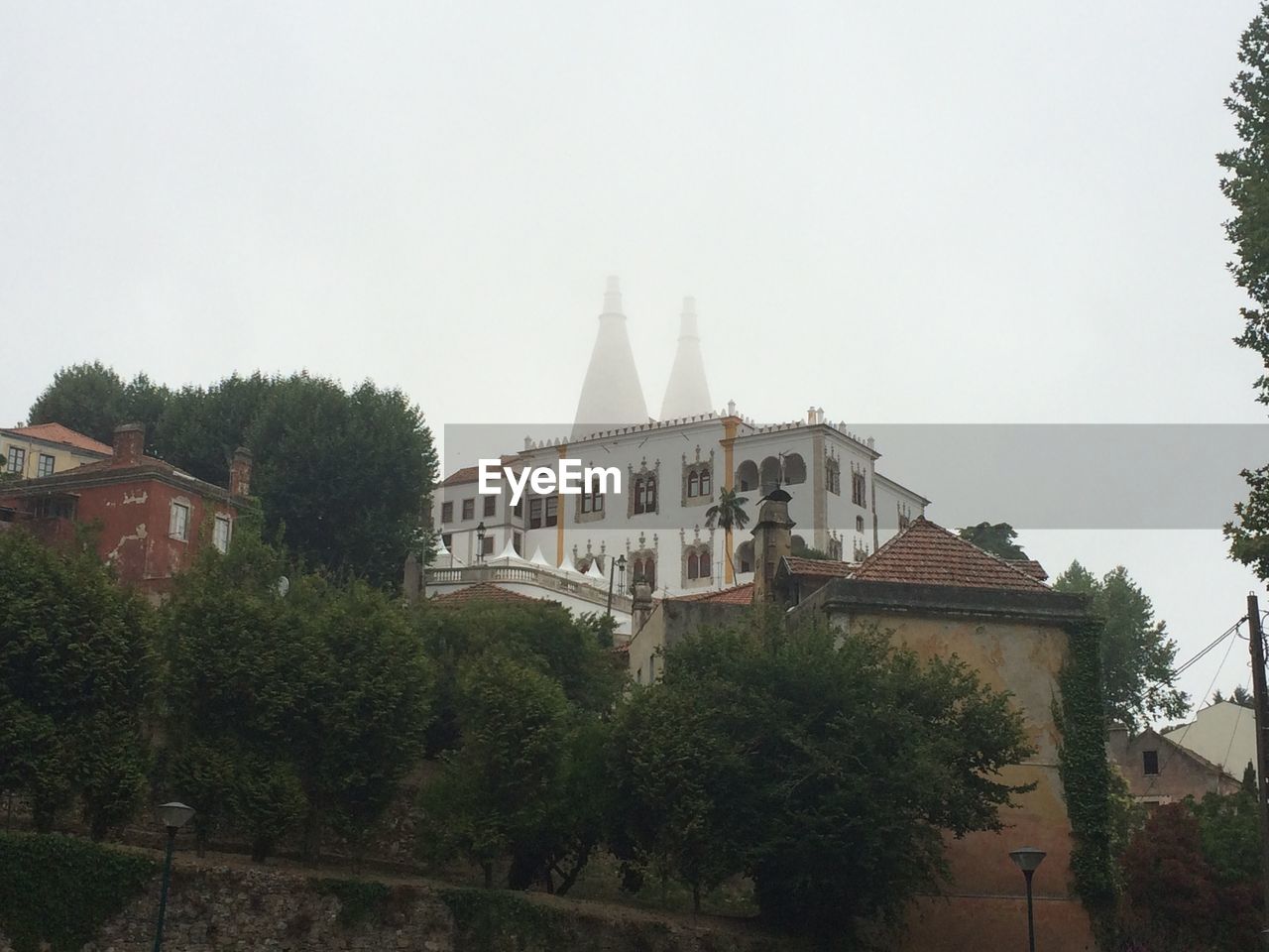 VIEW OF TEMPLE WITH BUILDINGS IN BACKGROUND