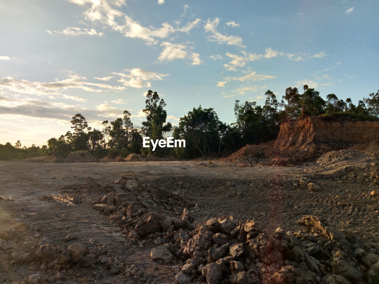 Rocks on field against sky