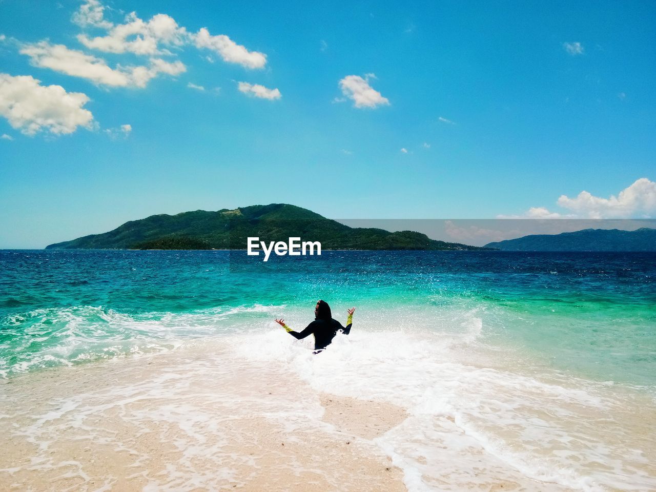 Rear view of man in sea against sky