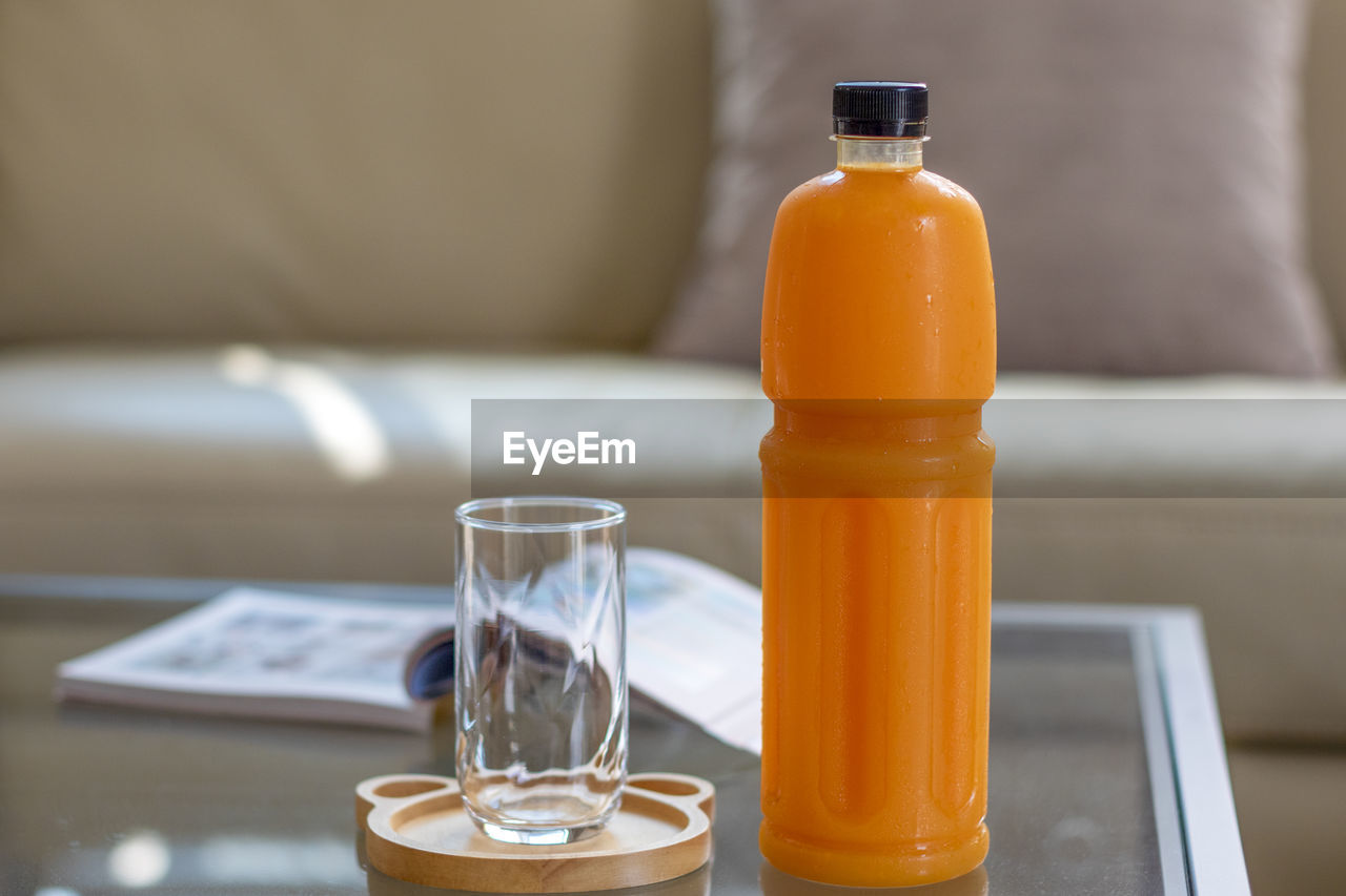 CLOSE-UP OF BEER GLASS WITH BOTTLES