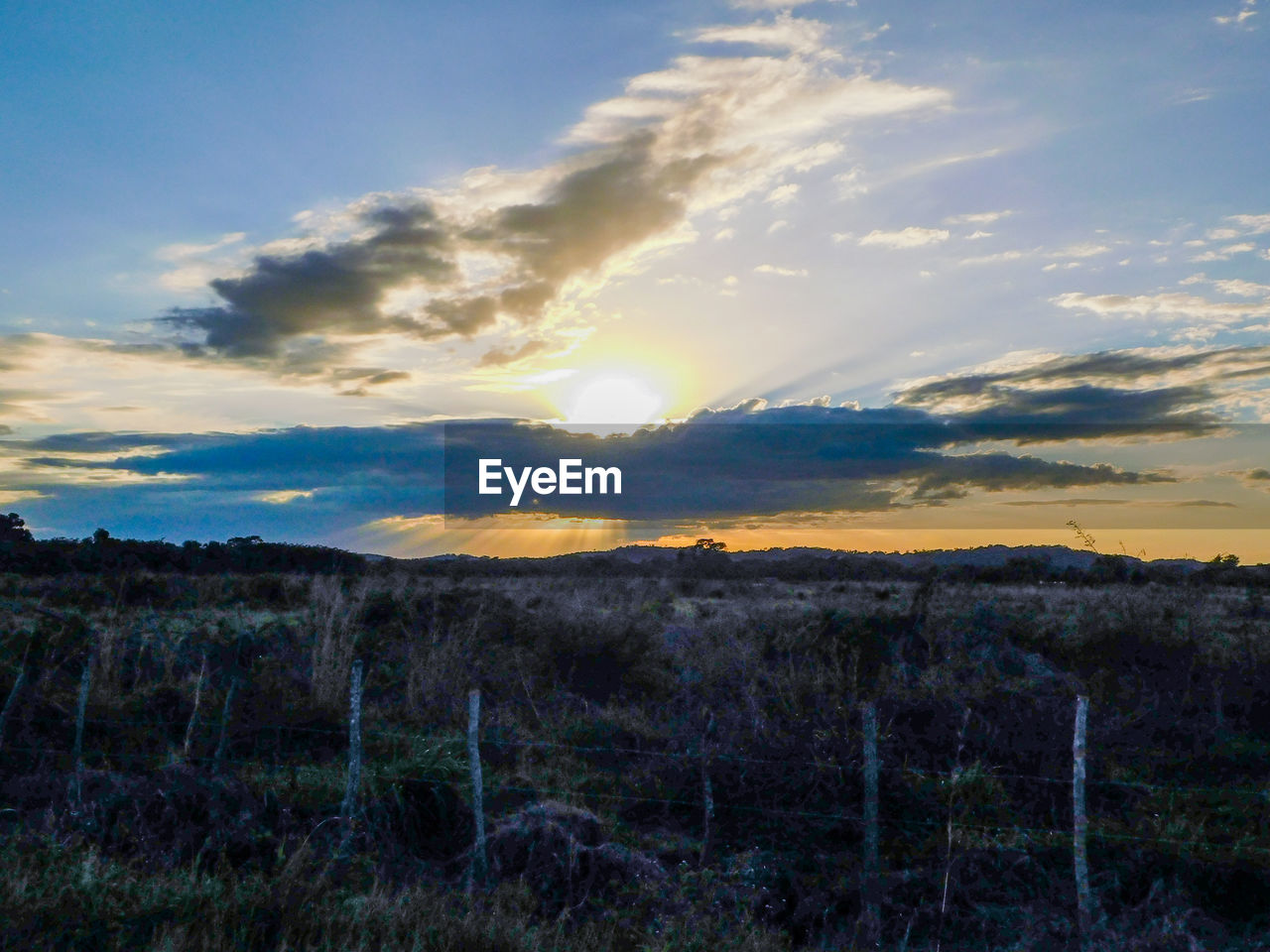 SCENIC VIEW OF SUNSET OVER LAND