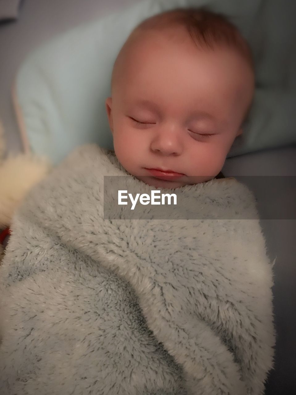 High angle view of cute baby boy sleeping on bed