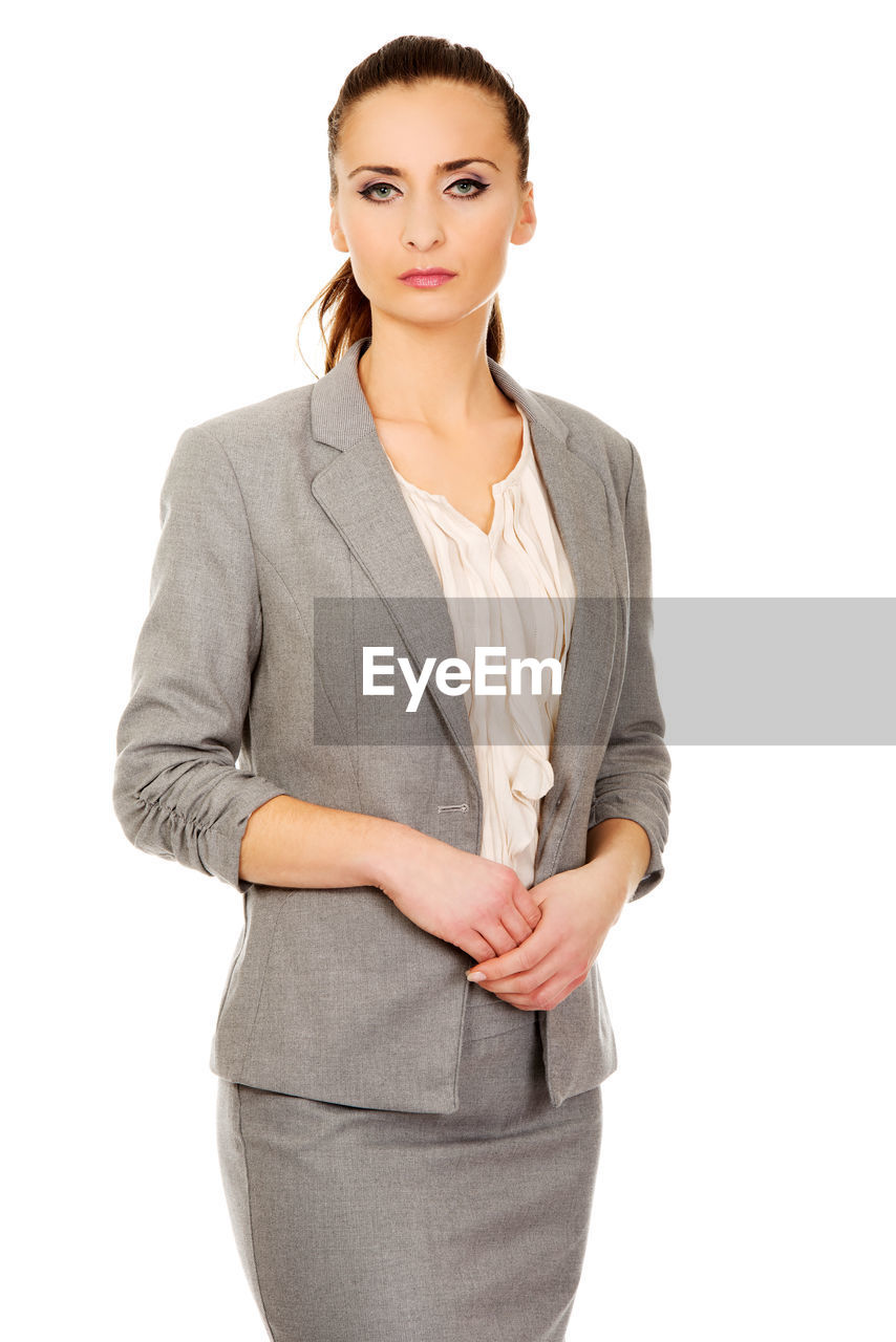 Portrait of beautiful businesswoman standing over white background