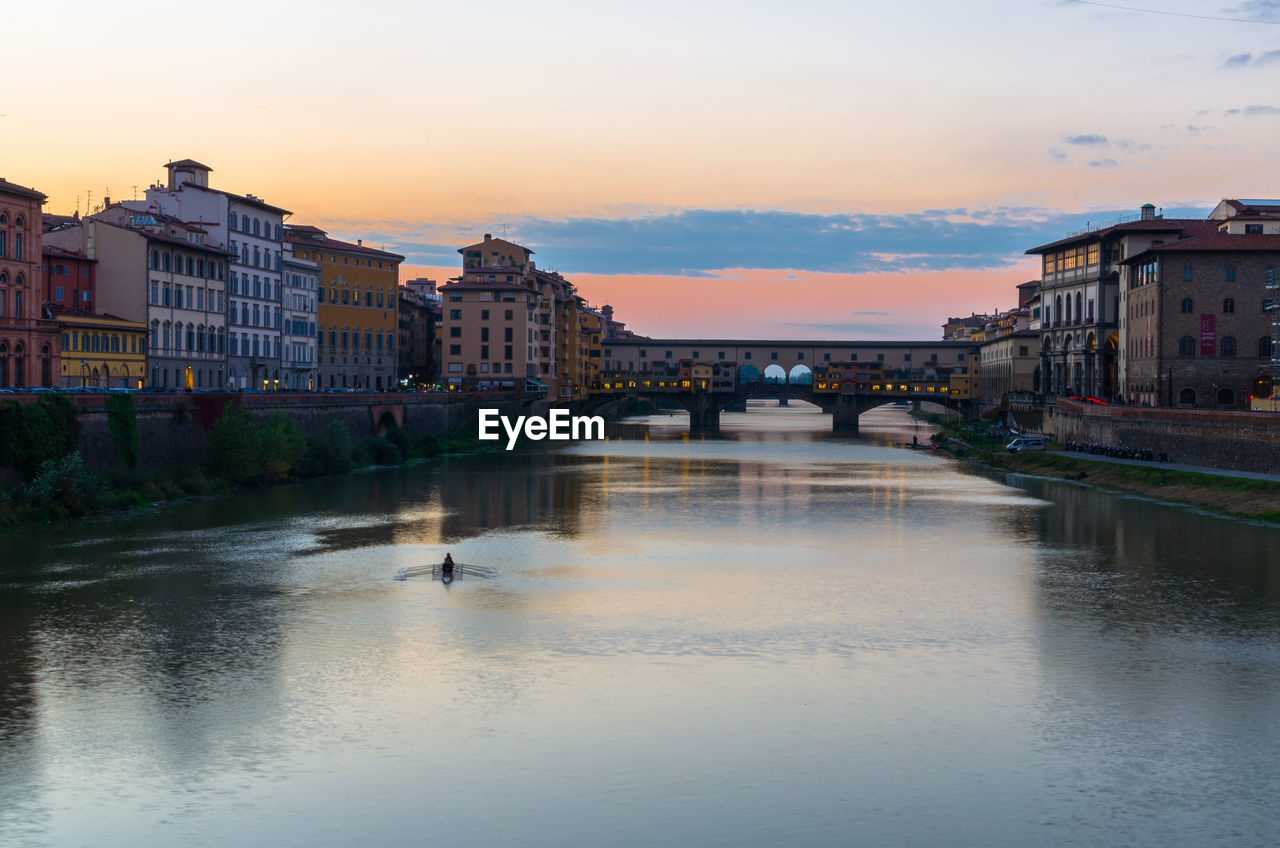 View of the ponte vecchio bridge over the arno during sunset, florence