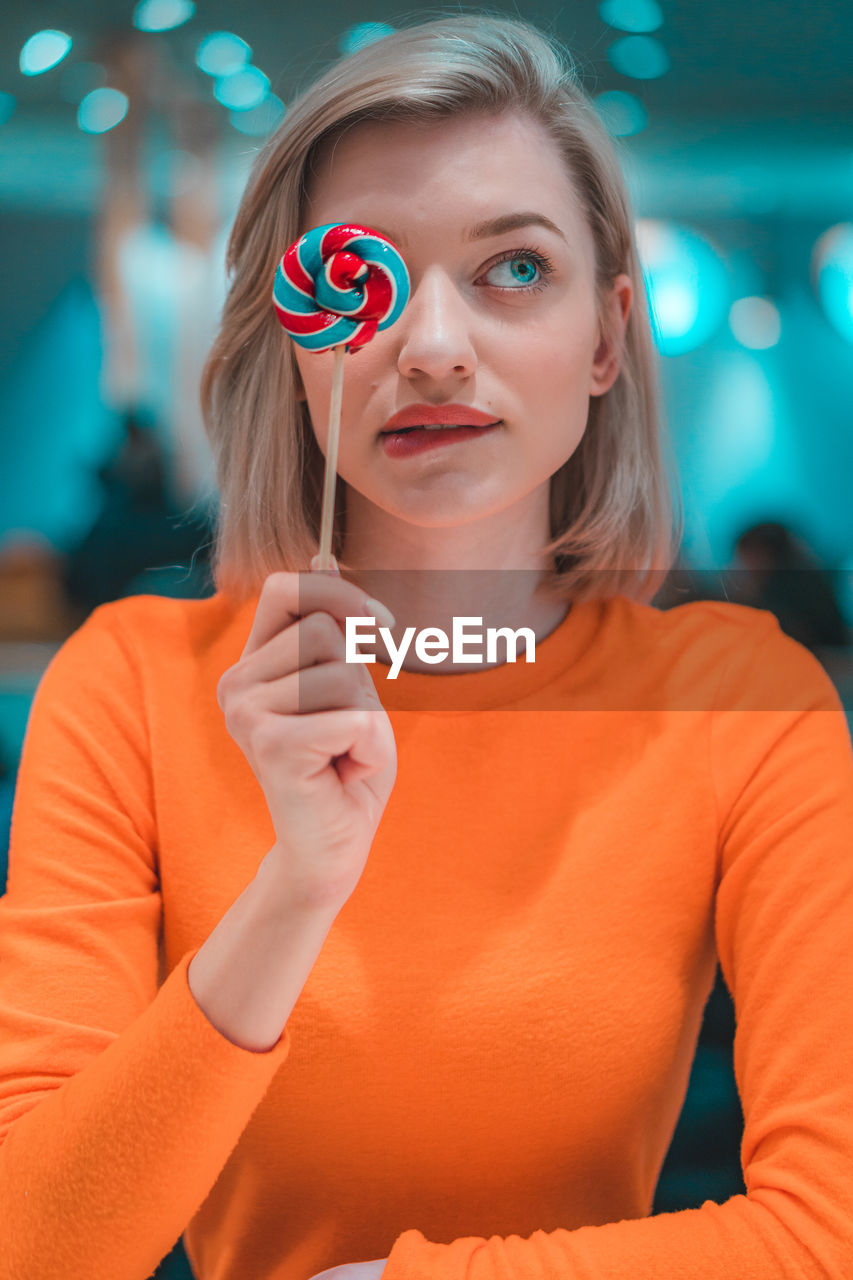 Close-up of woman holding lollipop