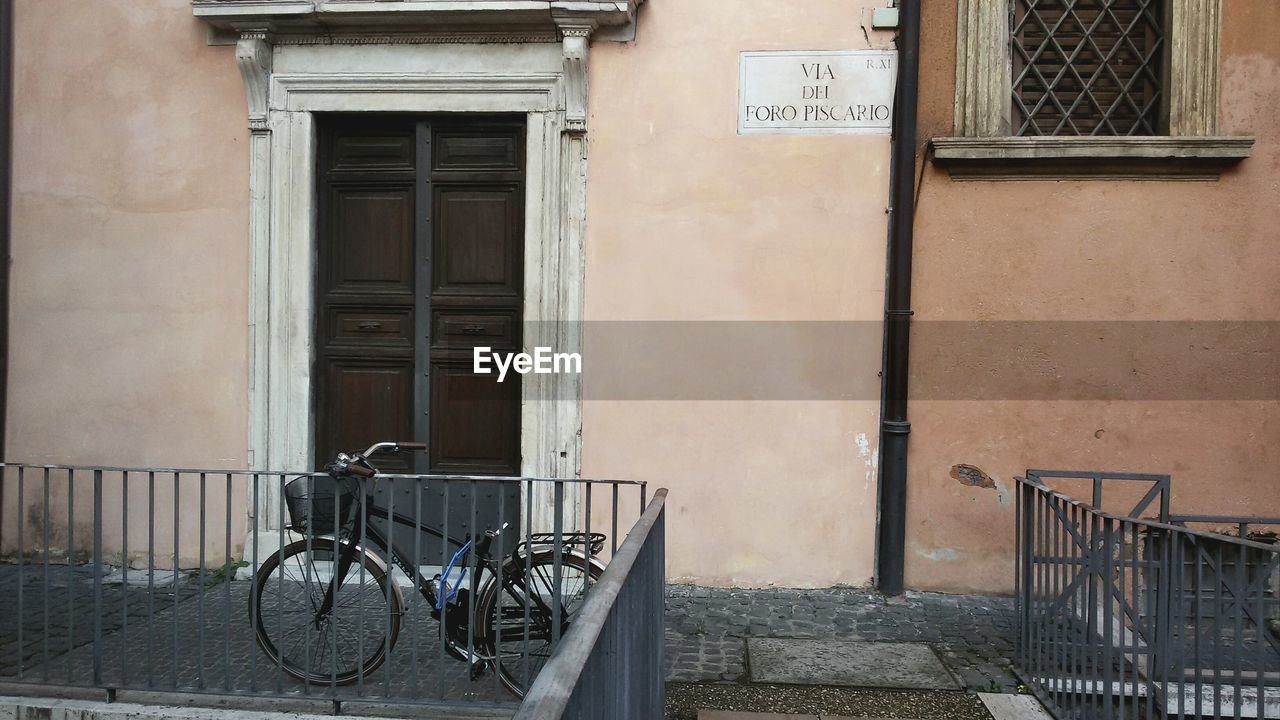 BICYCLE AGAINST BUILDING