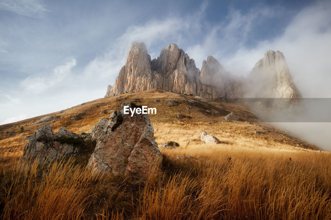 Morning dawn after rain with fog on the alpine of the caucasus mountains. stone castle. adygea.