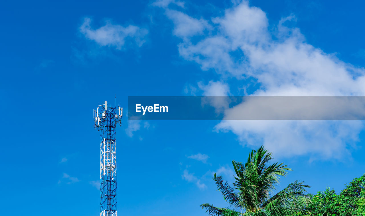 Telecommunication tower with blue sky and white clouds background. antenna on blue sky. 