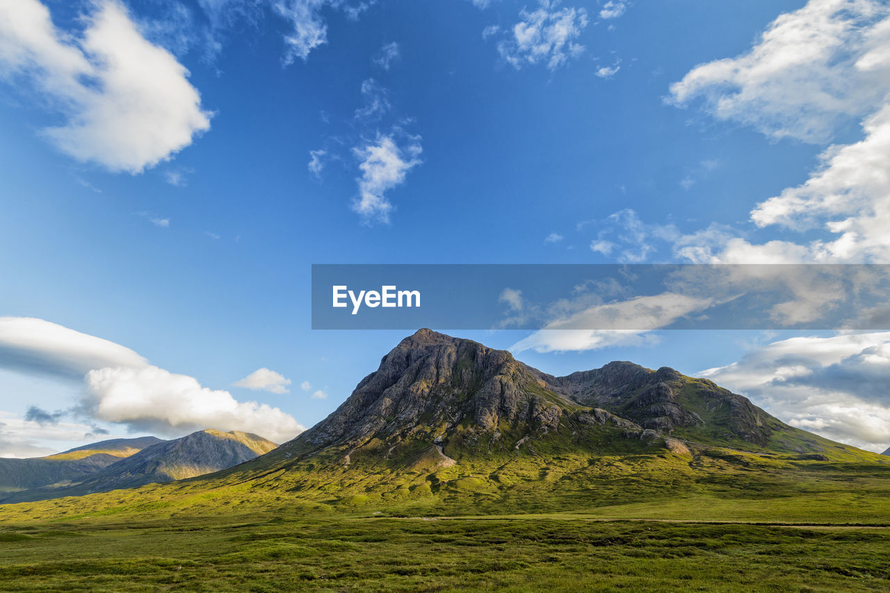 MOUNTAIN RANGE AGAINST CLOUDY SKY