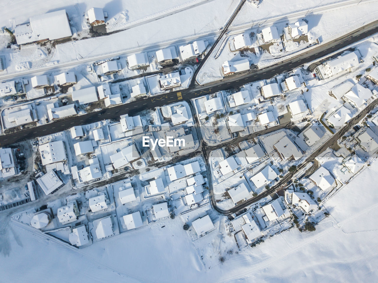 HIGH ANGLE VIEW OF SNOW COVERED BUILT STRUCTURES