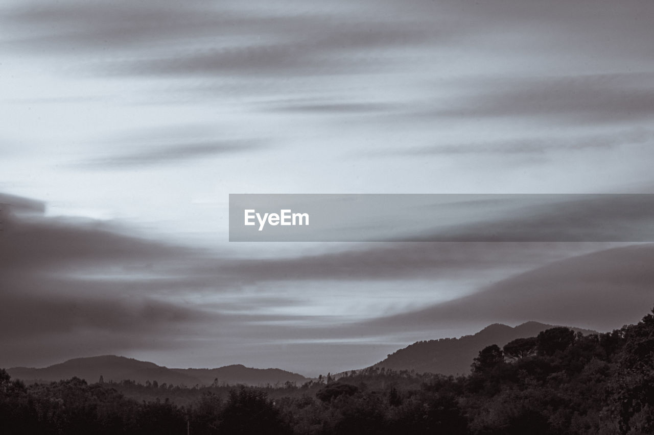 Scenic view of silhouette mountains against sky