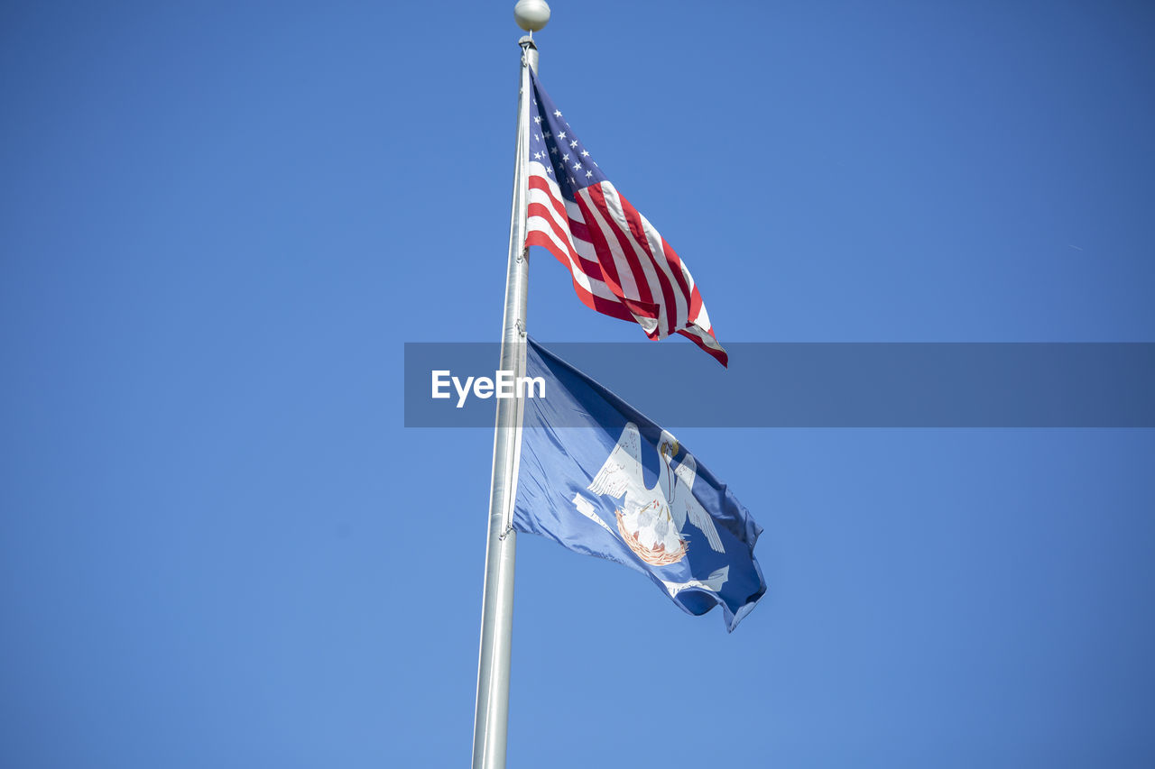 flag, patriotism, blue, sky, wind, clear sky, low angle view, nature, pole, independence, environment, no people, day, copy space, striped, symbol, emotion, sunny, outdoors, pride, symbolism, national icon, star shape, motion