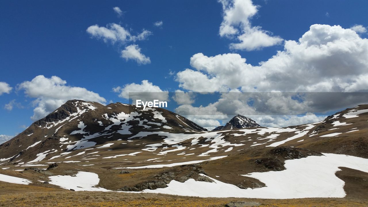 Scenic view of snowcapped mountains against sky