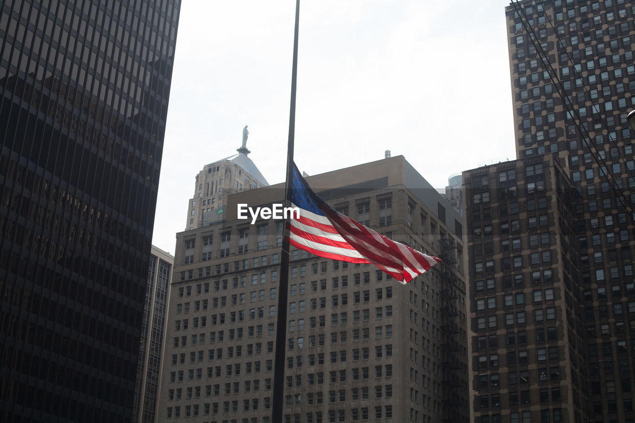 American flag outside city buildings