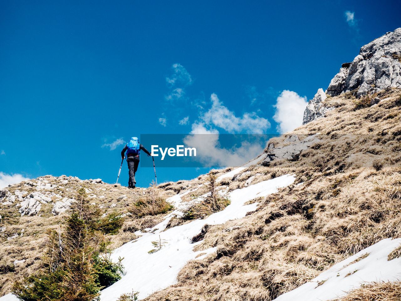 Low angle view of person hiking on mountain