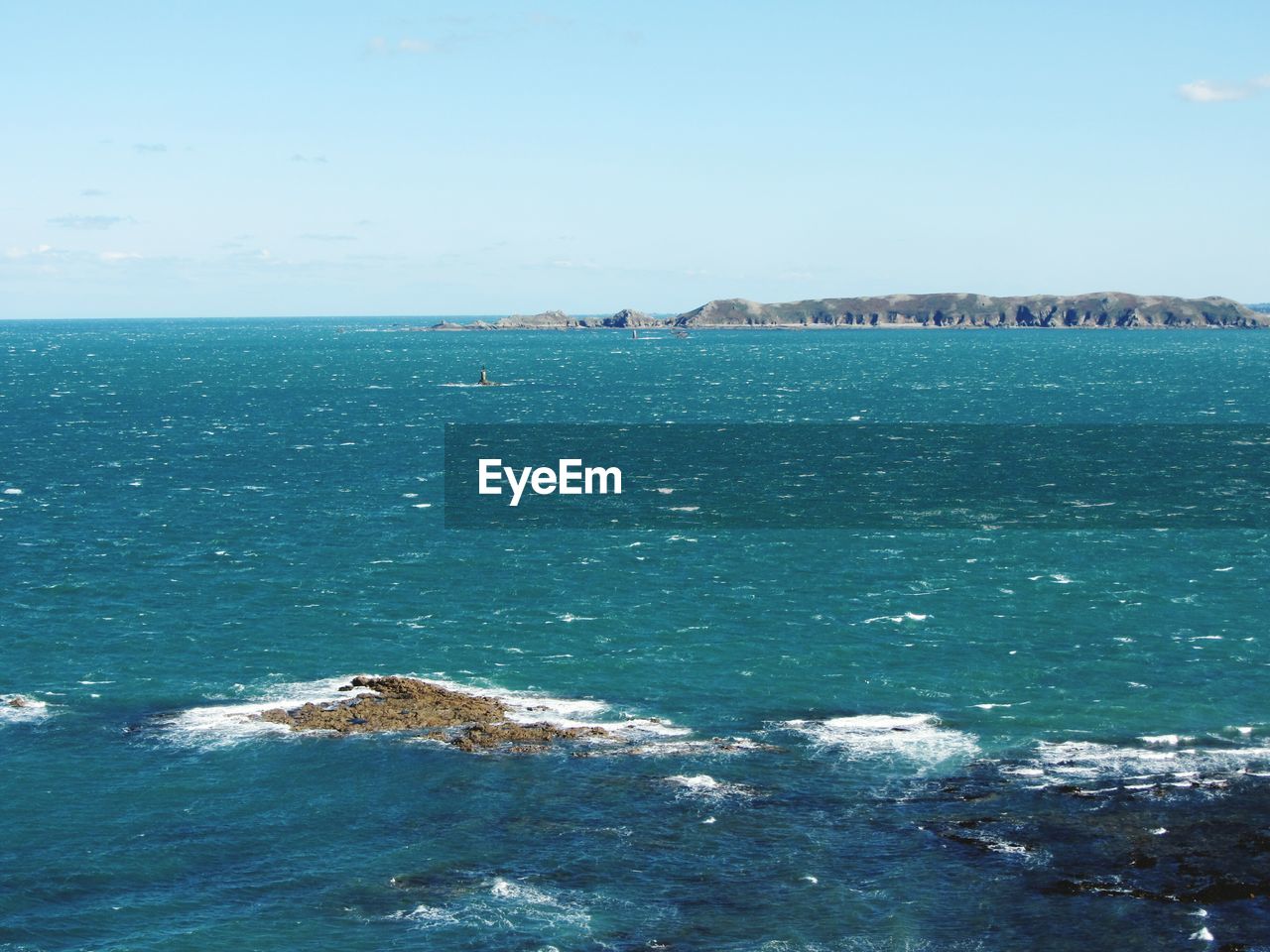 VIEW OF CALM SEA AGAINST BLUE SKY