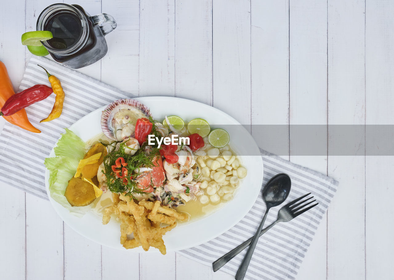 Typical peruvian food, squid ceviche, shrimp, crab and white fish with purple onion 