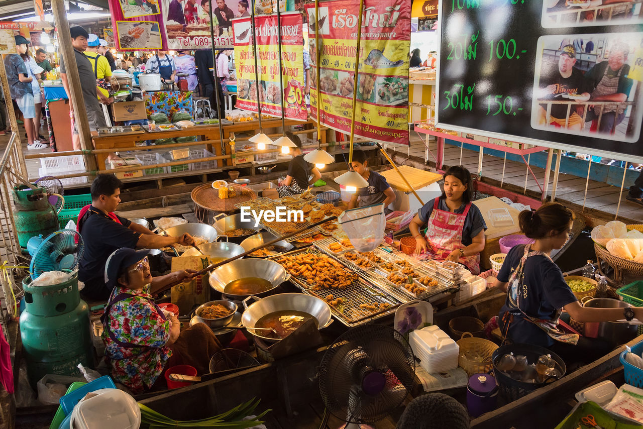 HIGH ANGLE VIEW OF PEOPLE AT MARKET