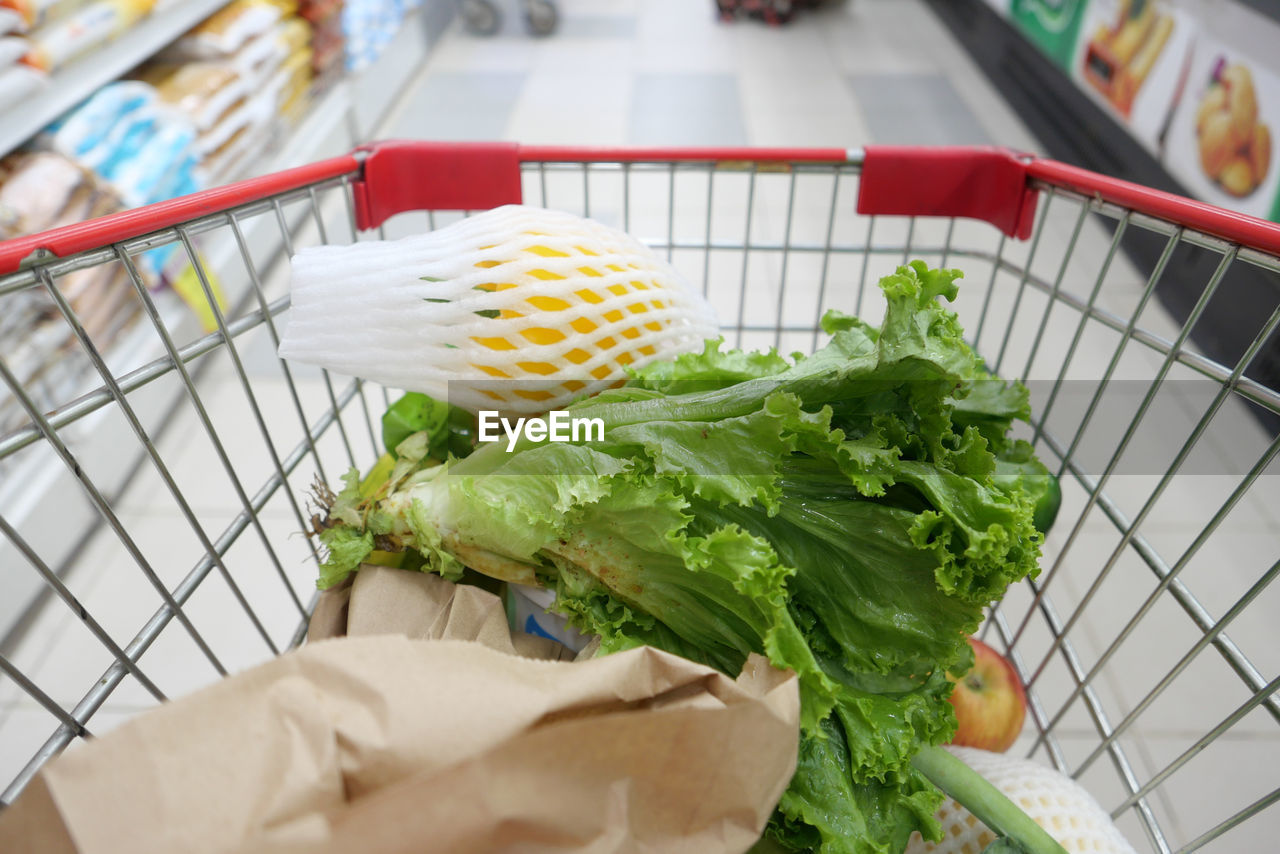 Fresh vegetables and fruits in a shopping trolly at store