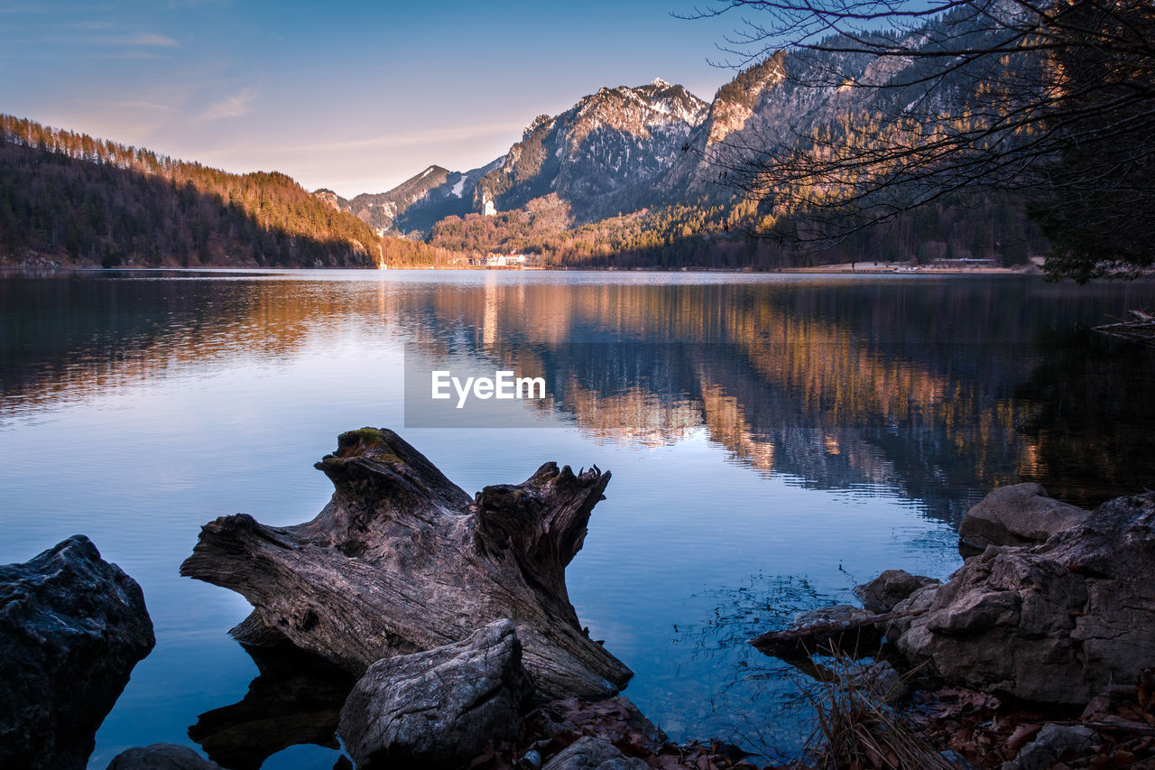 Scenic view of lake and mountains against sky