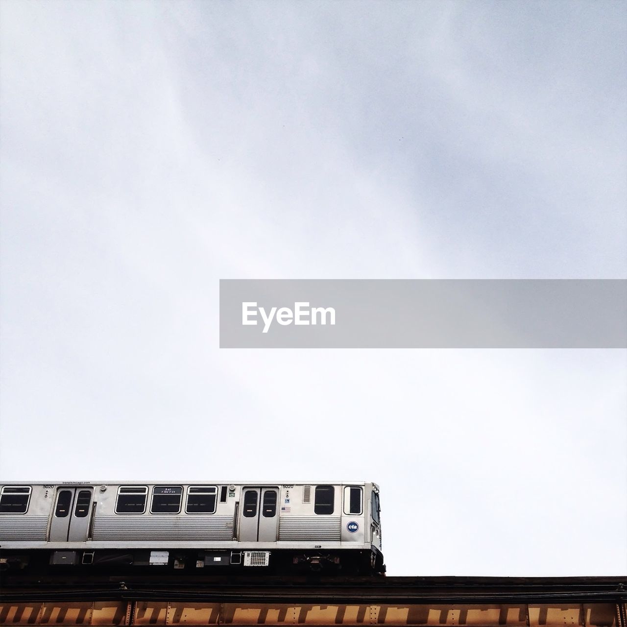 Low angle view of cropped train against sky