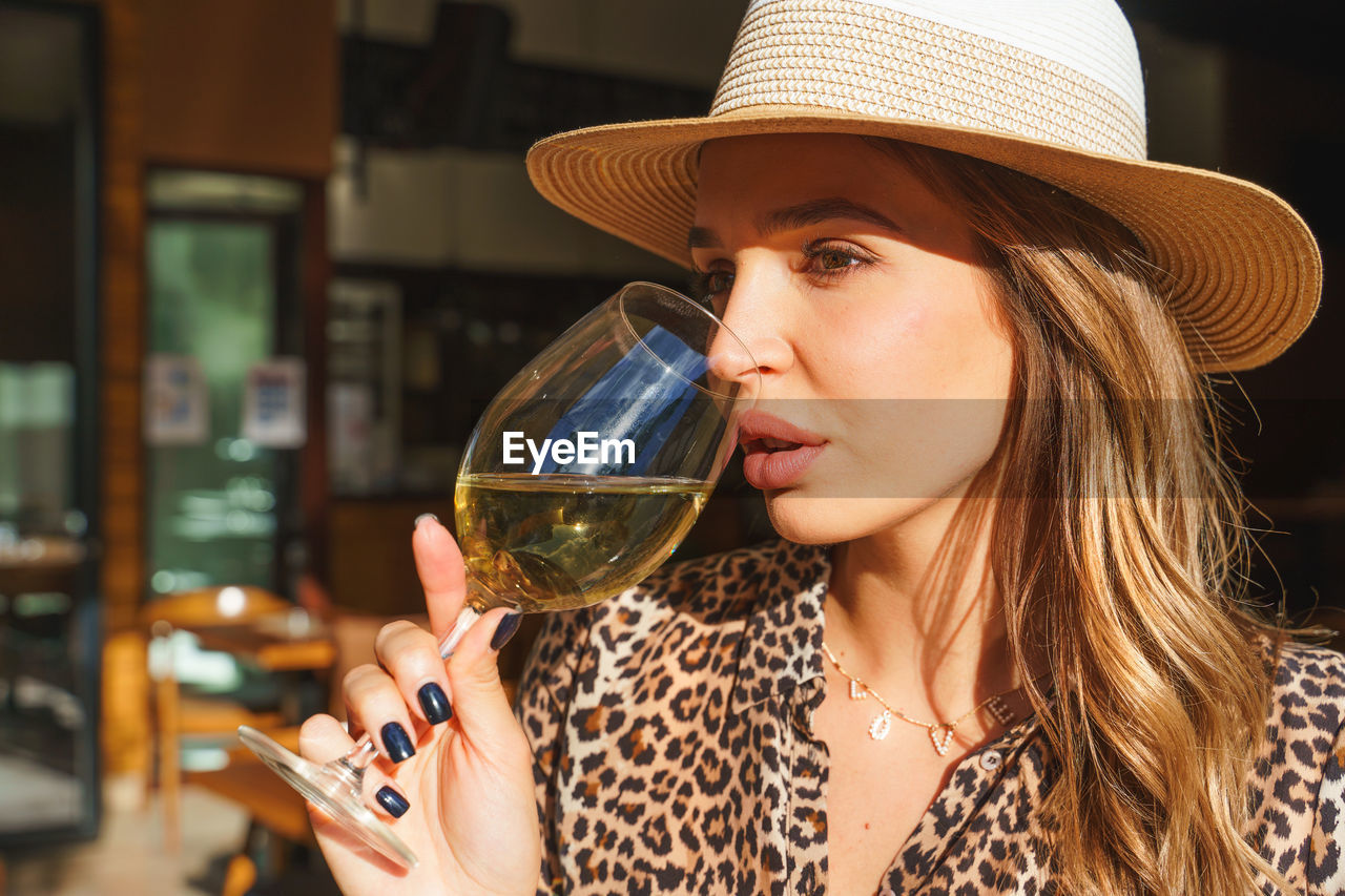 Young woman drinking wine at restaurant