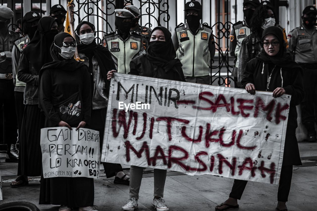 PEOPLE ON STREET AGAINST CITY