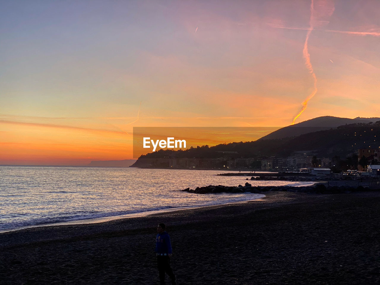 SCENIC VIEW OF BEACH AGAINST SKY DURING SUNSET