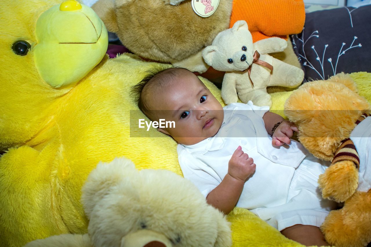 CUTE BABY BOY LYING ON BED