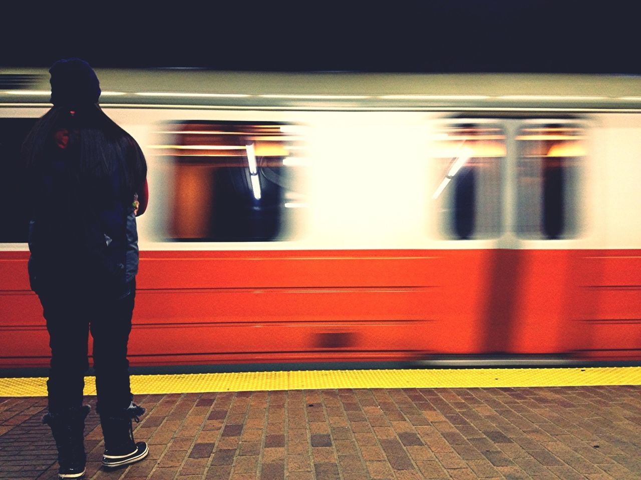 Full length rear view of man in front of train at station