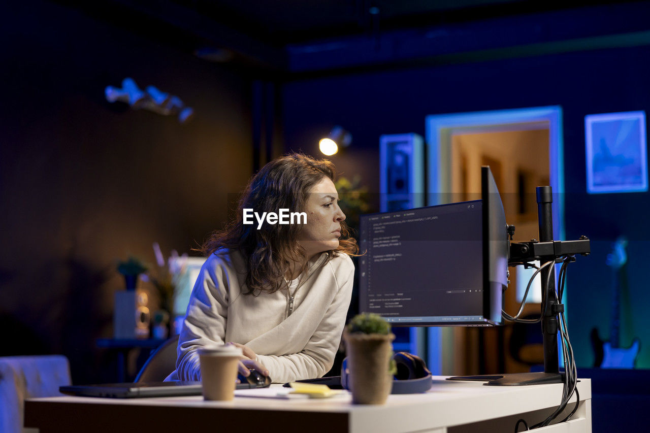 young woman using laptop on table in cafe