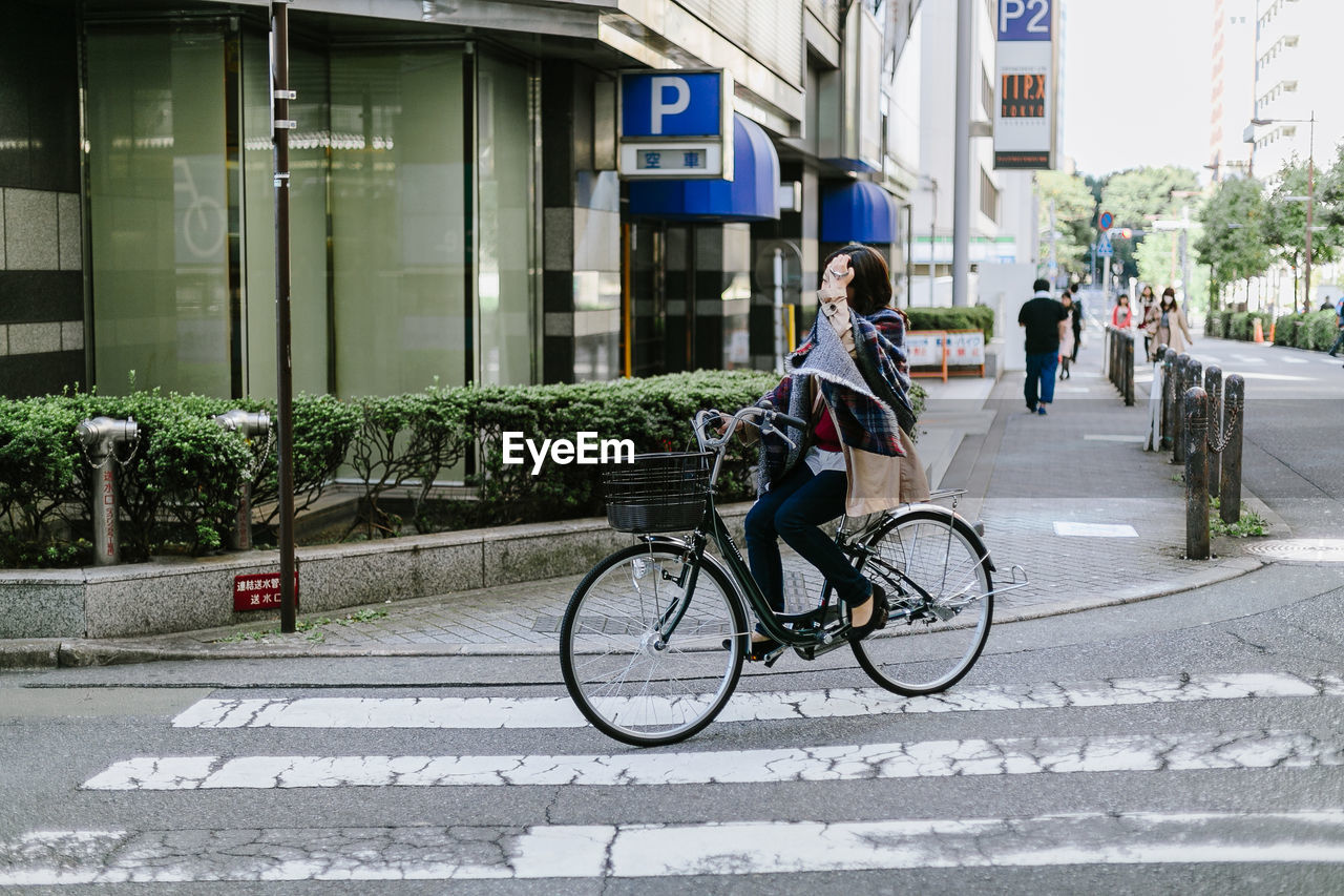 MAN RIDING BICYCLE ON STREET