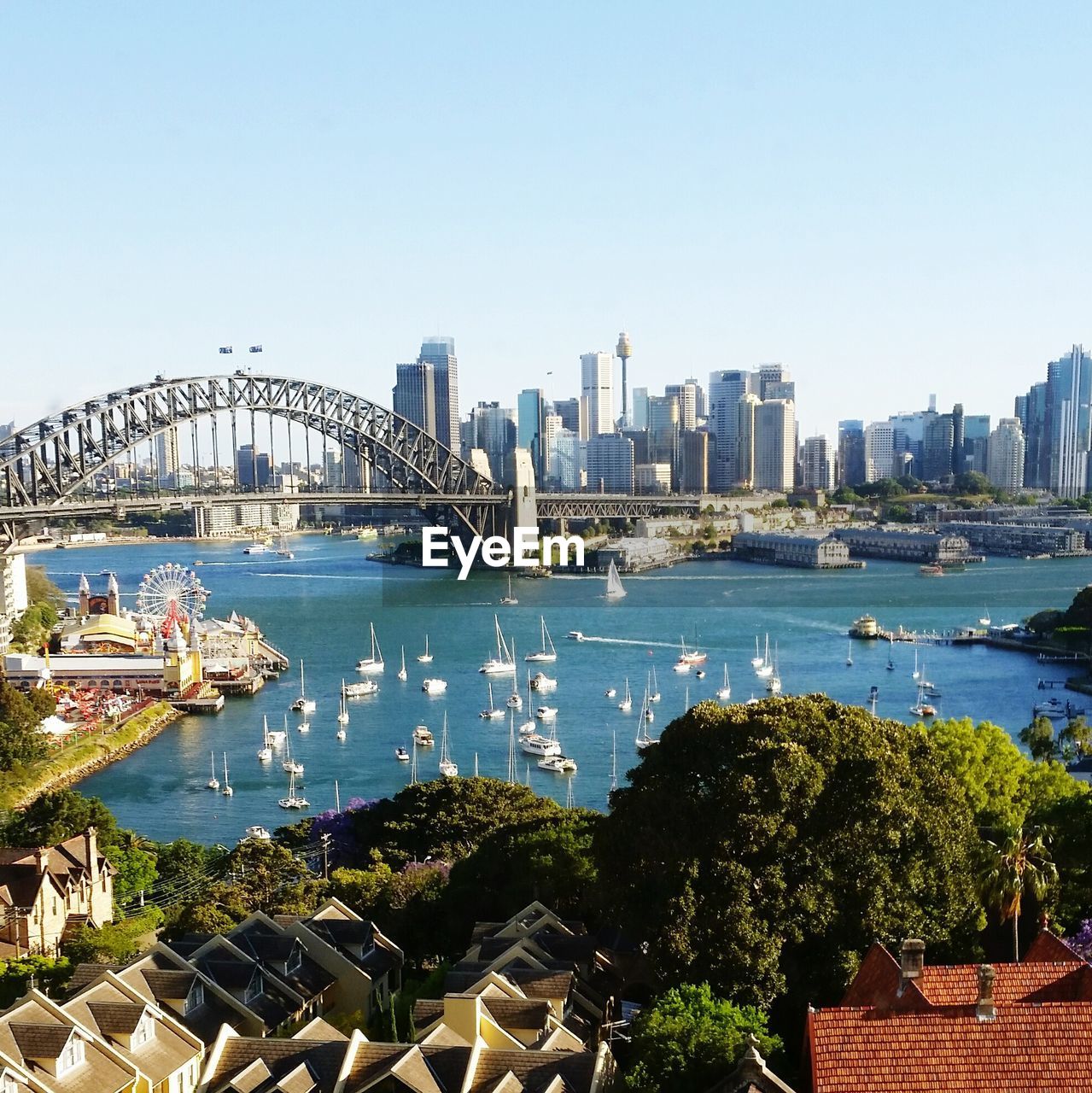 City at waterfront against clear sky