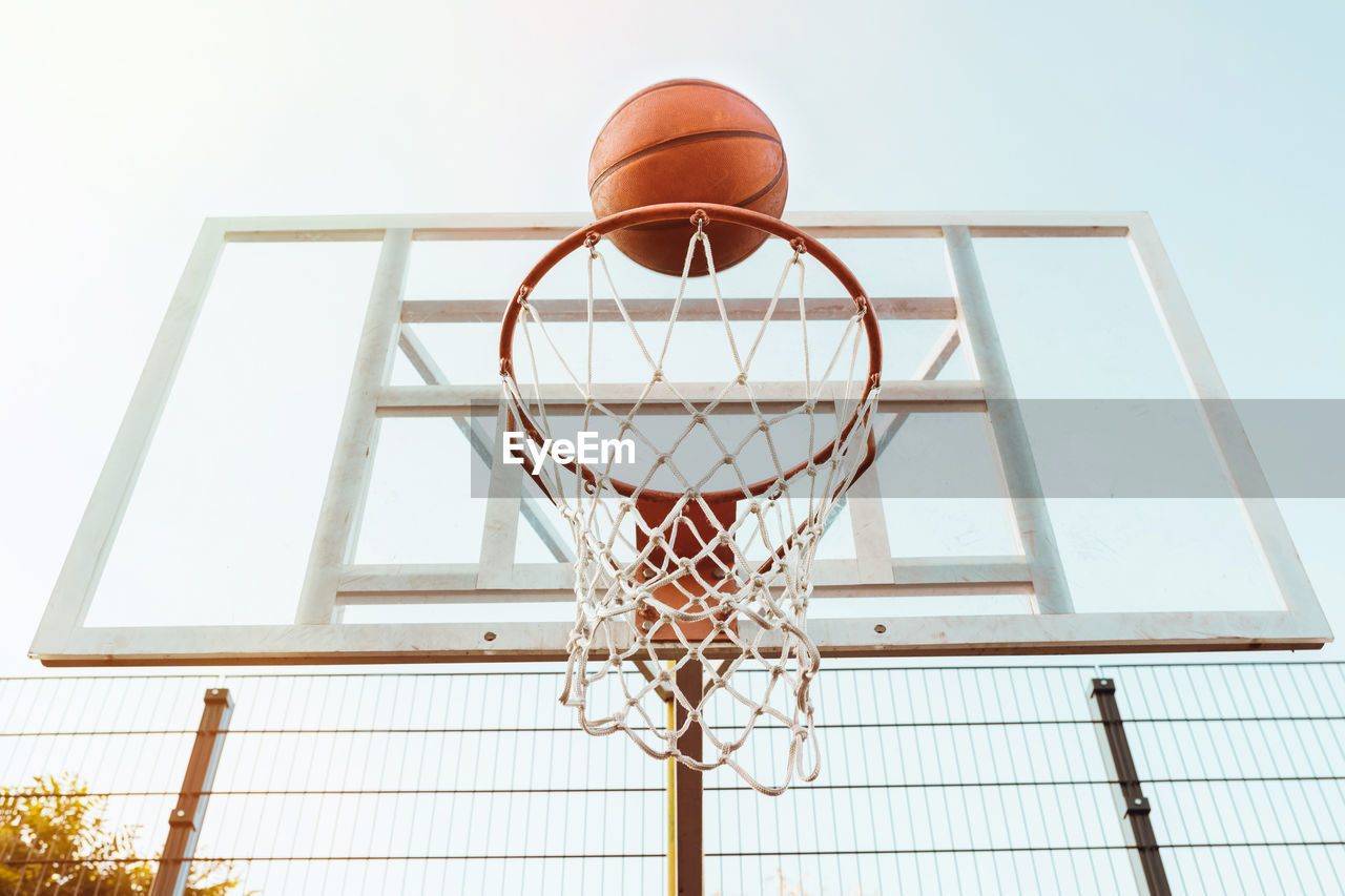 Ring and basketball ball on background of the sky and the city. sport lifestyle.