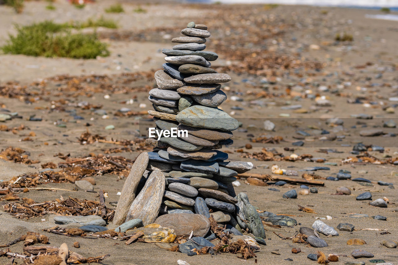 CLOSE-UP OF STACK OF STONES ON ROCK