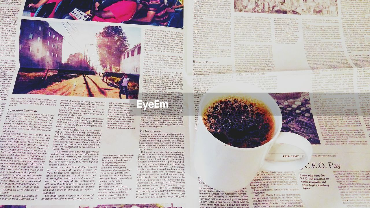 High angle view of black coffee on newspaper