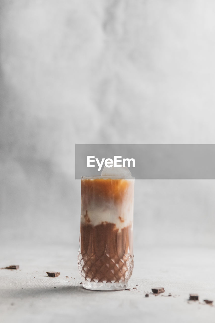 Close-up of iced coffee with chocolate layers on table