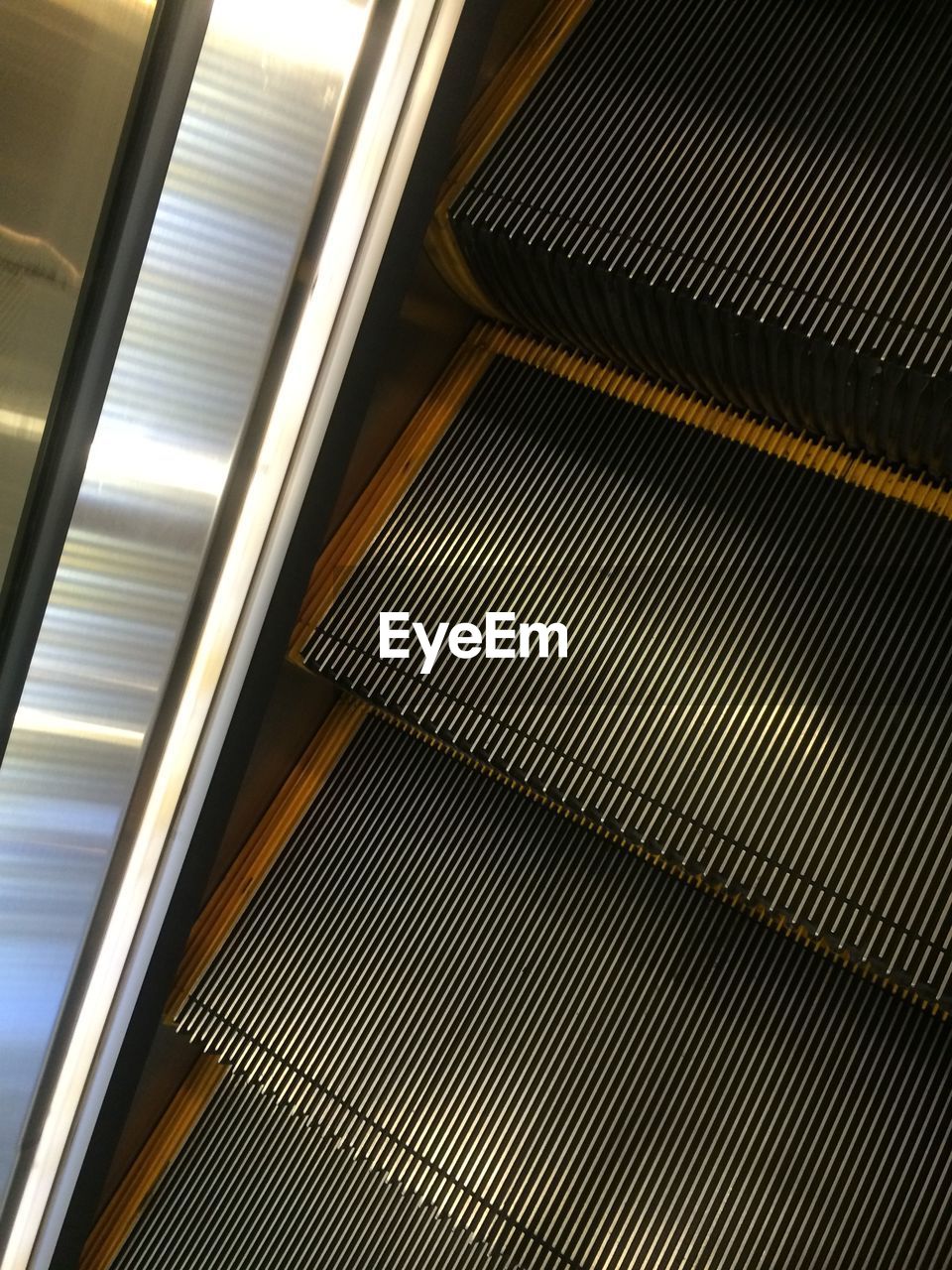 High angle view of cropped escalator